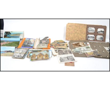A collection of vintage postcards and photograph albums dating from the early 20th century with views from vistas to portrait
