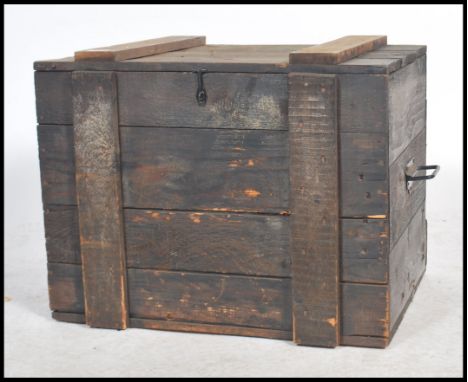 An early 20th century military type ebonised pine chest trunk having slatted panel wood construction with hinged top above.&n