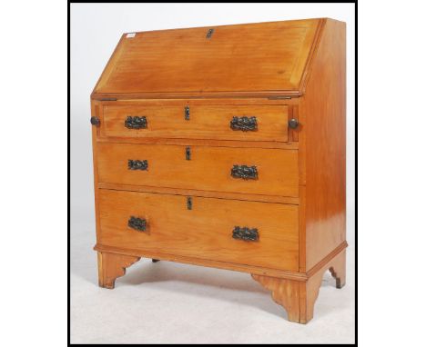An early 20th century satin wood writing bureau, on bracket legs with bank of drawers beneath fall front bureau opening to re