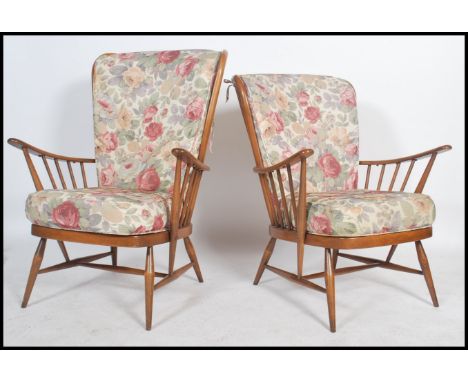 A good pair of 20th century retro Ercol Windsor armchairs. The turned legs united by stretchers having spindle back rests and