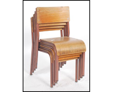 A set of four vintage green painted tubular steel framed child's school stacking chairs with moulded plywood seats and back r