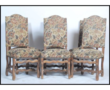 A set of 19th century French walnut high back dining chairs. Each raised on shaped legs with crinoline stretchers. The chairs