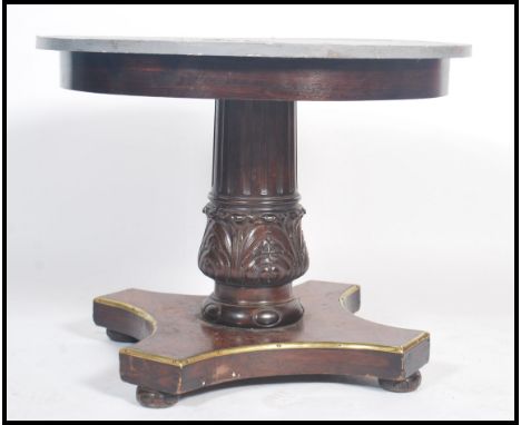 A 19th century French mahogany and gilt painted centre table / dining table having tripod base with gilt painted edgees, carv