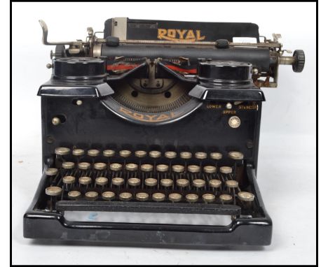 A vintage early&nbsp; 20th century typewriter by Royal with glass panels to side, logo for Royal to top. Measures 26 cm high,