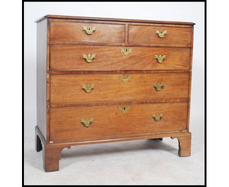 A Georgian mahogany 2 over 3 chest of drawers being ebony line inlaid with brass swing handles and batwing escutcheons. Raise