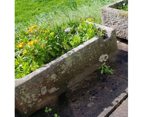 An  antique 19th century natural stone trough  of rectangular shaped form being hewn hand carved with cut recess to  one end 