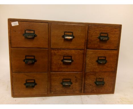 A vintage industrial early 20th century 1930's bank of nine industrial oak index&nbsp; filing cabinet.&nbsp;Each drawer fitte