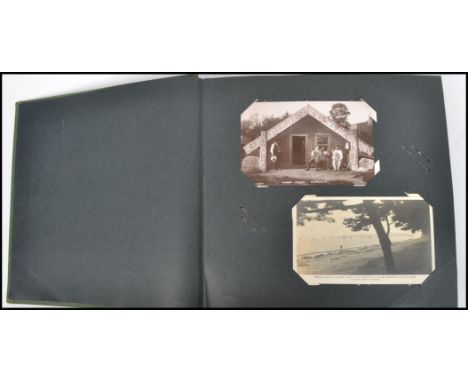 A vintage 20th century postcard album containing various topographical, real photo cards, 1920s Japanese earthquake postcards