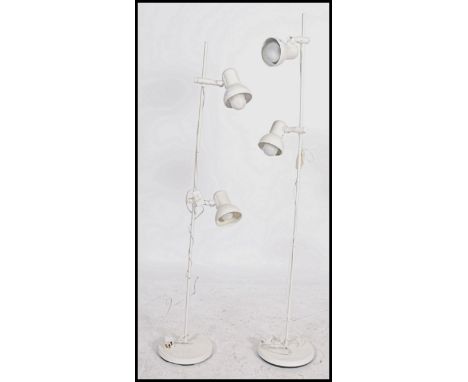 A pair of retro 20th century matching floor standing adjustable multi light spot lamps raised on circular bases with pendant 