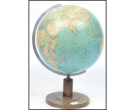 A vintage 20th century large retro desk top globe raised on wooden circular base.