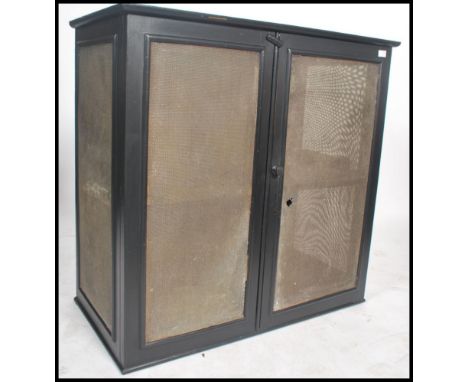 A large vintage early 20th century meat safe locker of ebonised pine construction with mesh lined doors and panel sides