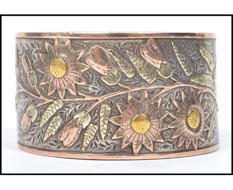 A 19th century believed Russian silver and gilt decorated napkin ring of half moon shape adorned with flowers and leaves. Wei