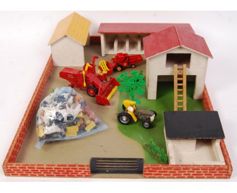 An original vintage Britains wooden farm yard playset comprising of base board, farm out houses, plastic farm yard animals, b