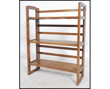 A 20th century retro folding table top display shelf. Slatted supports with folding panel wood shelving. Measures 94cms by 71