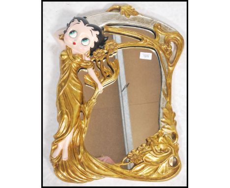 A vintage 20th century Betty Boop gilt framed mirror in the art nouveau style featuring the iconic character in a gilt dress 