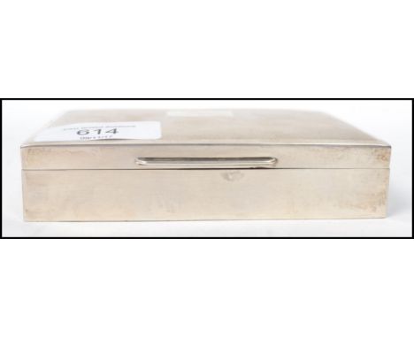 A vintage mid 20th century silver hallmarked cigarette tobacco box by&nbsp;Harman Brothers having an engine turned lid with c