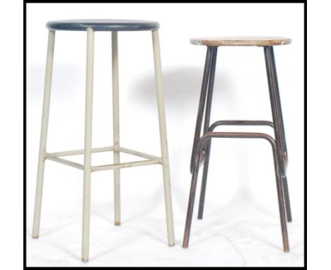 Two vintage retro 20th century industrial machinist stools of tubular form one having makers plaque for Dual. Measures 71cms 