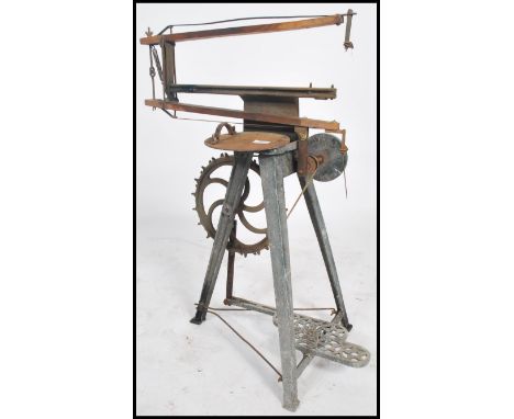 A vintage 20th century industrial Hobbies cast metal pedal foot powered fret saw raised on tripod support. Measures 87cms hig