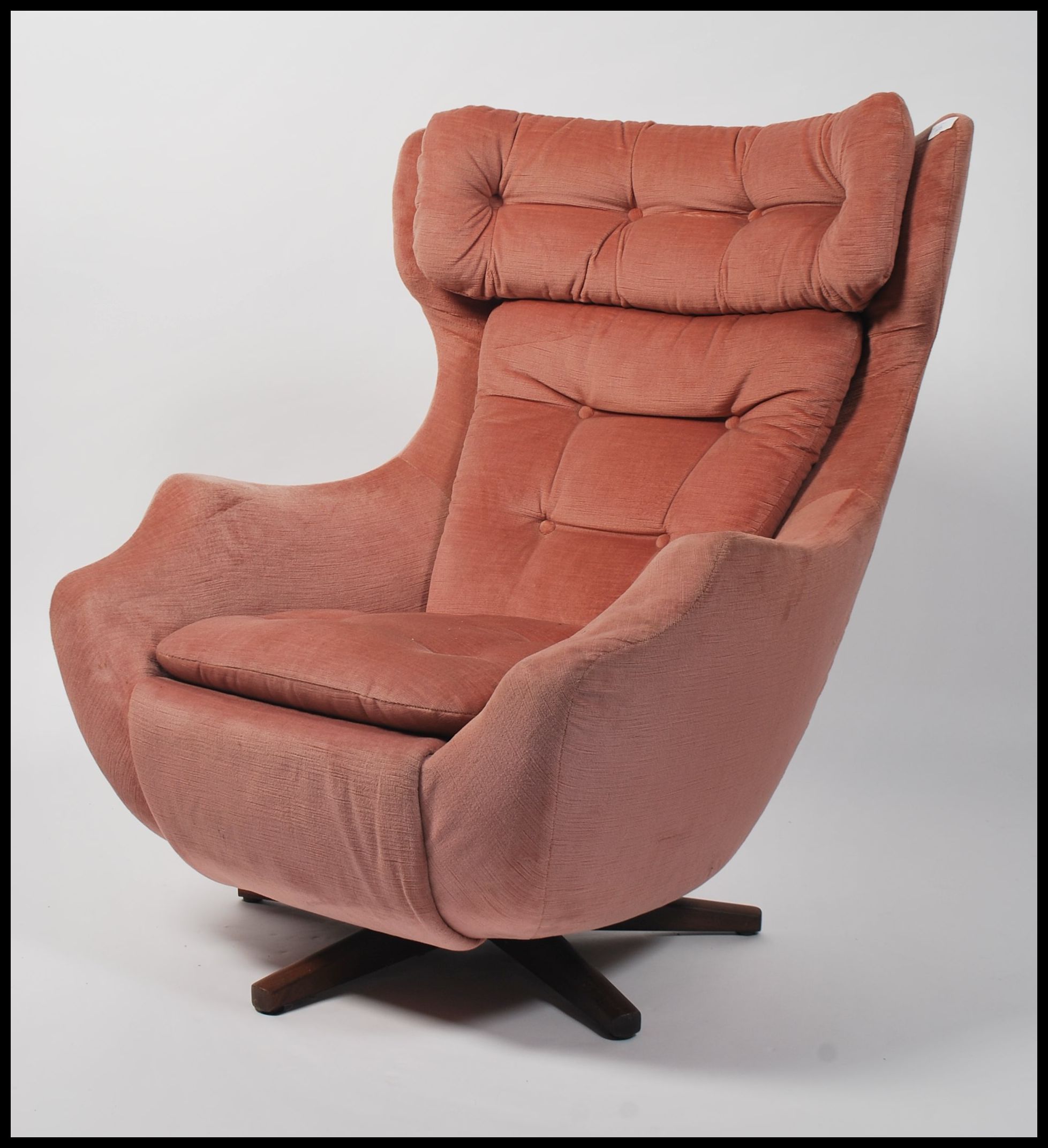 A 1960's Parker Knoll large batwing swivel egg chair armchair being