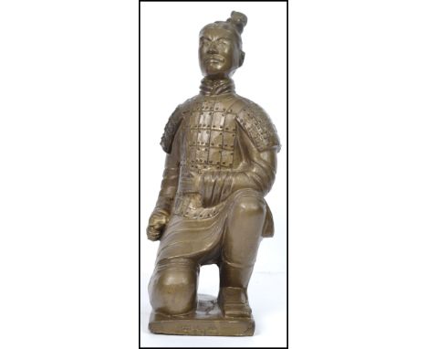 A large gilded plaster Chinese figurine of a terracotta army soldier in the kneeling&nbsp; position, raised on plinth base wi