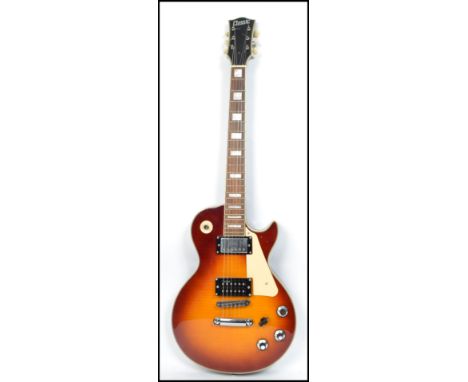 A Classic six string vintage electric guitar having a shaped body with burnt effect body.