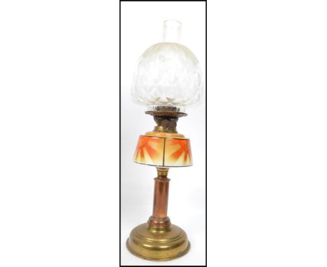 A 1930's Art Deco&nbsp; brass and glass oil lamp having sunburst decorated glass reservoir over brass column. Fitted with gla