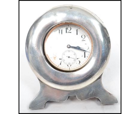 A silver hallmarked easel backed pocket watch stand of circular form with pocket watch having an enamel face with faceted han