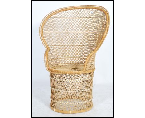 A vintage 20th century / late 1970's retro wicker peacock armchair chair. Large open back chair with woven seat. Measures 109