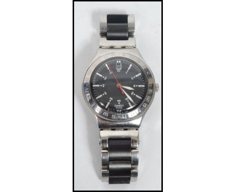 A vintage gentleman's Swatch Swiss Irony watch set on a stainless steel bracelet, the black dial having baton numerals with f