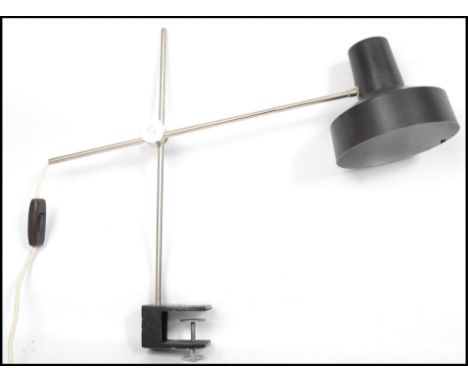 A vintage 20th century retro industrial Eastern European chrome and bakelite adjustable work desk lamp raised on a clamp base