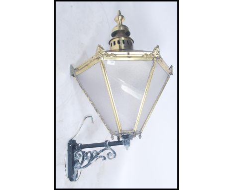 A large 19th century Victorian street lamp of hexagonal form having tapering glass panels with original wrought iron mounts. 