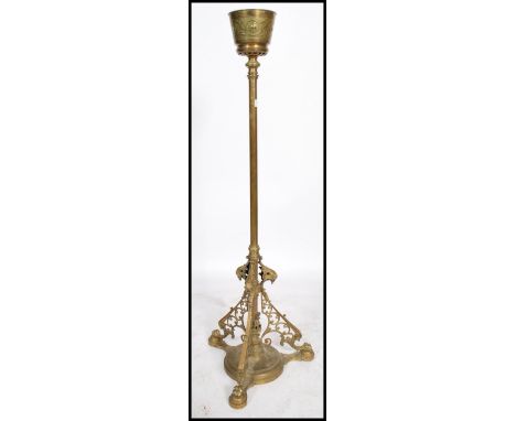 A 19th century Victorian heavy brass oil lamp stand raised on a pierced scrolled tripod base with grotesque lion mars column 
