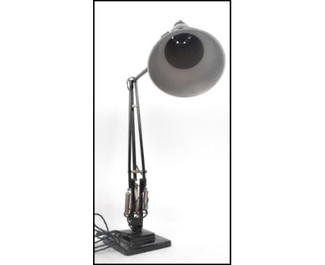 A 1940's Industrial pre-war Herbert Terry anglepoise lamp, raised on a cast metal two step base with pendant shade, finished 