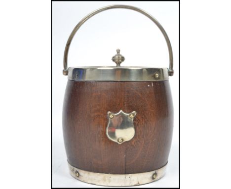 A vintage 20th century silver plated biscuit barrel in the form of a coopered barrel having white metal bands, a plain armori