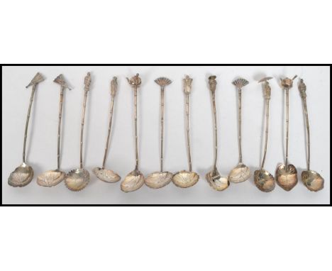 A set of twelve vintage 20th century Japanese silver hallmarked coffee / tea spoons, the bowls in the form of leaves with var