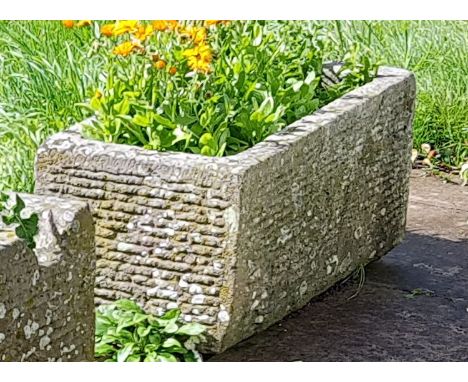 An antique 19th century deep natural stone trough  of rectangular shaped form being hewn hand carved and with an arched inter