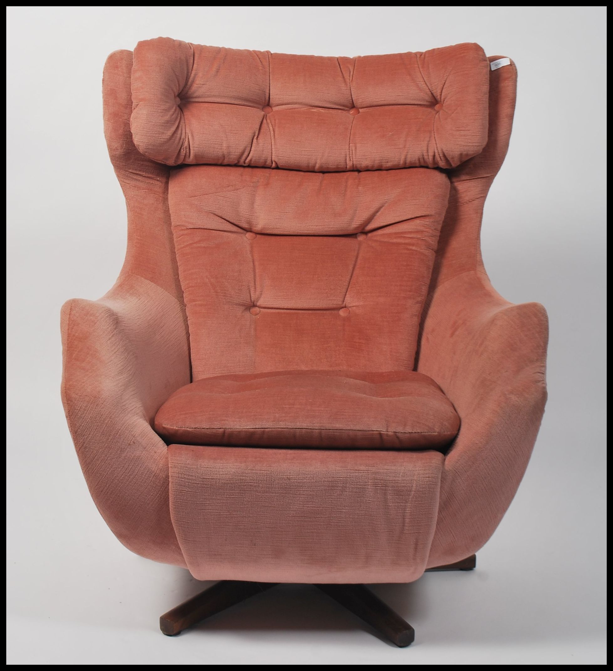 A 1960's Parker Knoll large batwing swivel egg chair armchair being