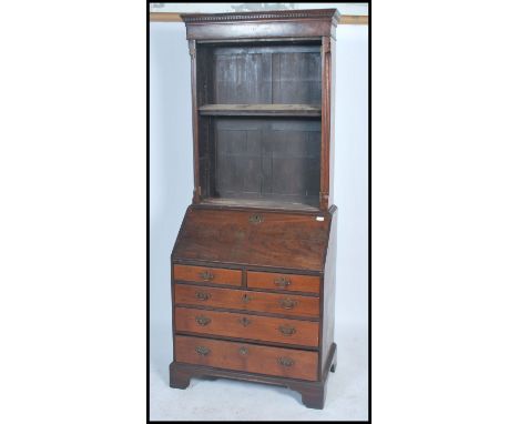 An 18th century Georgian mahogany bureau bookcase. Raised on bracket supports having short and graduating drawers beneath fal