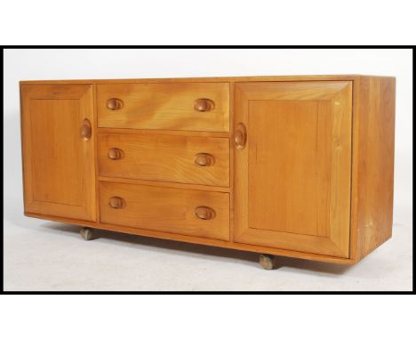 A 20th century&nbsp;light elm and&nbsp;beech wood sideboard by Ercol with three central drawers, the top fitted with cutlery 