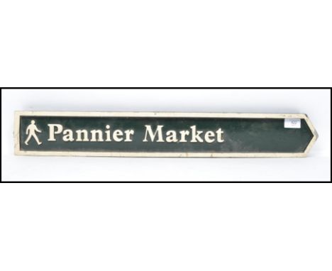 A vintage 20th century North Devon street road metal sign reading Pannier Market having a dark green ground with white letter