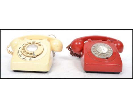 Two vintage mid century retro ring dial telephones in red and beige colourways with phones atop.