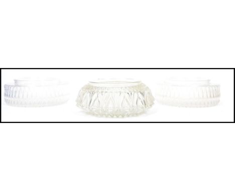 A group of three vintage mid century glass ceiling light shades of pressed glass form. Two being a pair and one of similar fo
