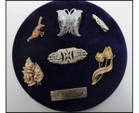 A collection of sterling silver dress brooches to include a enamel pheasant brooch, Niello butterfly brooch, Celtic knot swir