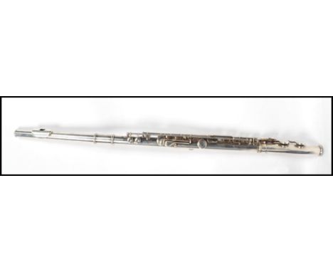 A vintage early 20th century cased flute with makers marks for Taylor J James complete within a velvet lined case.