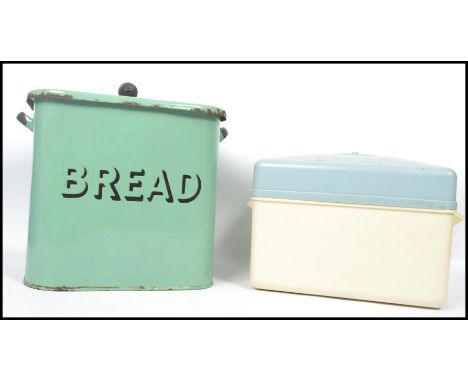 A retro 1950's green enamel bread bin having central notation with lid together with a 1980's plastic retro bread bin. Highes
