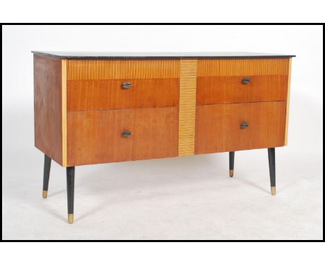 A vintage retro 20th century sideboard of small proportions having an ebonised top with four drawers and cross banded design 