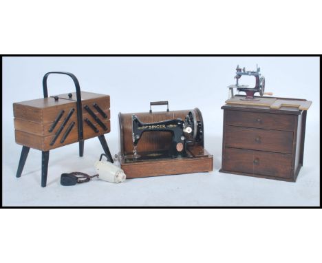 A vintage mid century sewing box with contents together with a chest of drawers with contents and a Singer sewing machine in 