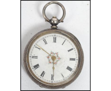 An early 20th century silver 835 marked ladies open faced key wind pocket for watch. Rococo chased case with enamel dial, dec