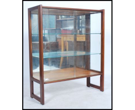 A vintage teak wood 20th century display cabinet with squared solid teak outer frame, mirror back with 2 glass shelves and sl