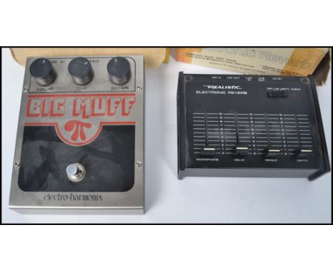 A vintage Realistic Electronic Guitar Reverb in the box together with boxed Big Muff guitar foot pedal by Electro Harmonix. B